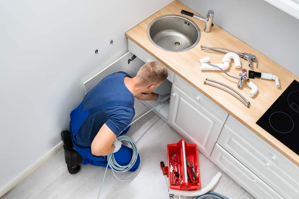 Plumber Cleaning Clogged Sink