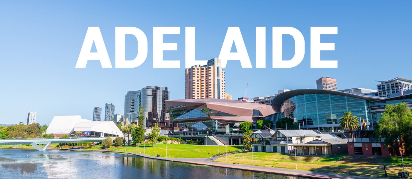 Skyline of Adelaide with modern buildings and a river in the foreground under a clear blue sky. Large white text across the top reads "ADELAIDE.