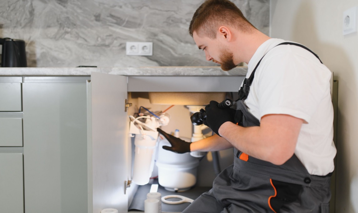 A Reverse Osmosis (RO) system being installed by a professional. These systems are one of the most effective ways to remove trace chemicals and improve water taste at home.